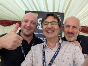 Alan Harrison flanked by "Craig and Dave" at the Festival of Computing 2025.